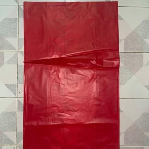 Red garbage bag laid flat